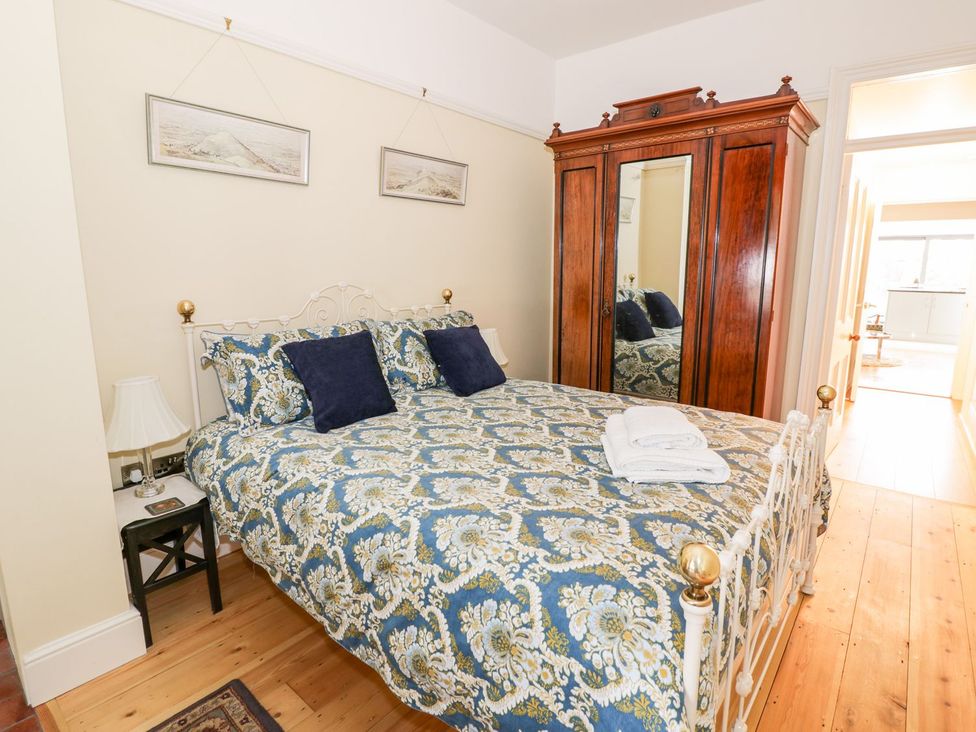 A bedroom with a bed and wardrobe at Little Mornington in Malvern
