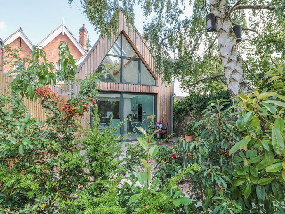 A house surrounded by plants and trees at Little Mornington in Malvern
