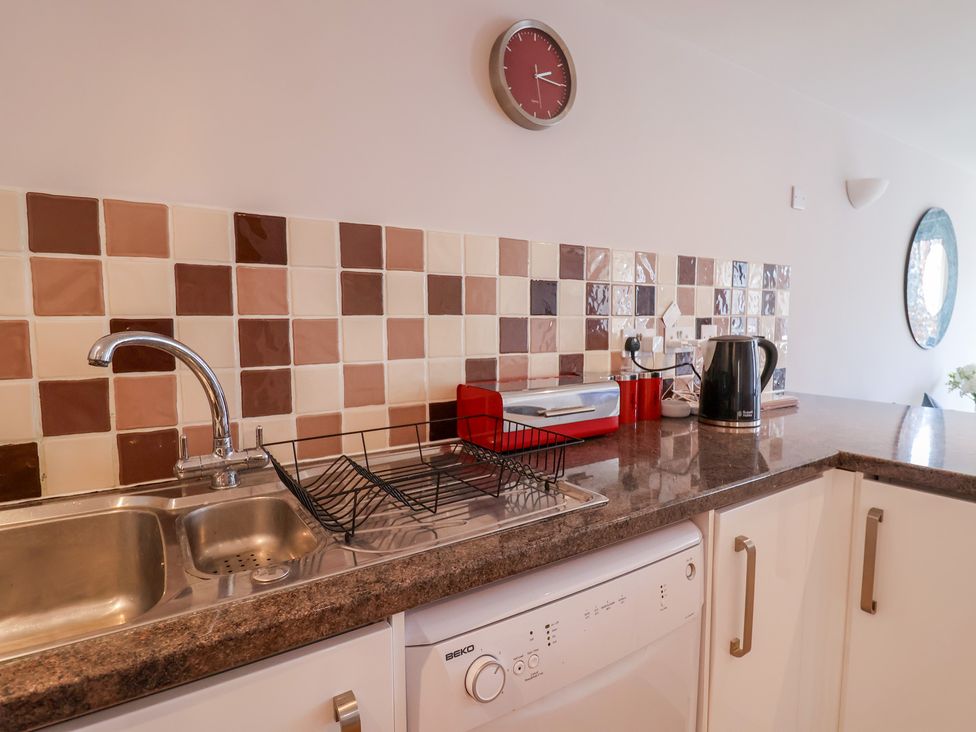 A kitchen with a sink and a dishwasher at Beck House in Weymouth