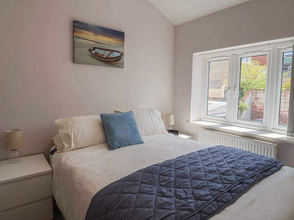 A bedroom with a bed and nightstand at Beck House in Weymouth