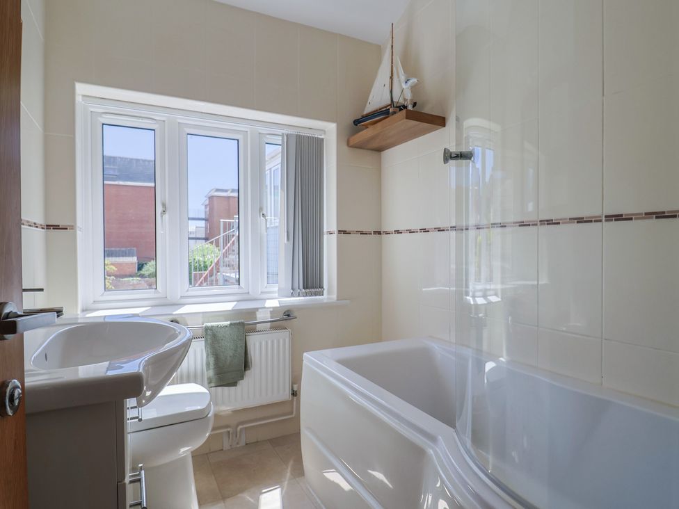 A bathroom with a sink, toilet, and bathtub at Beck House in Weymouth