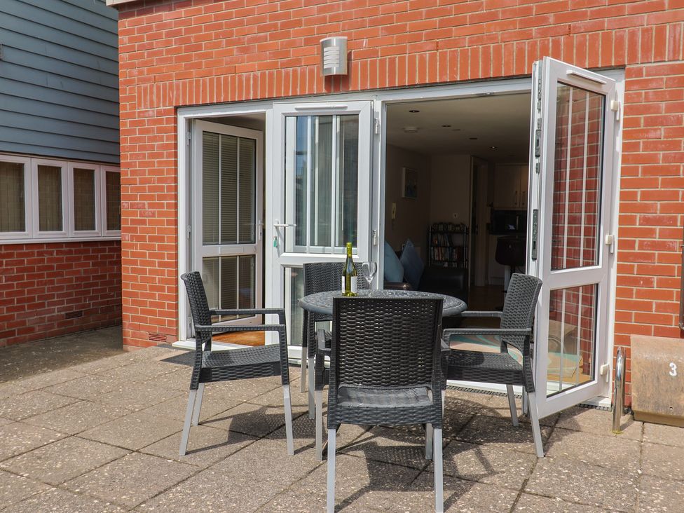 An outdoor area with a table and chairs at Beck House in Weymouth