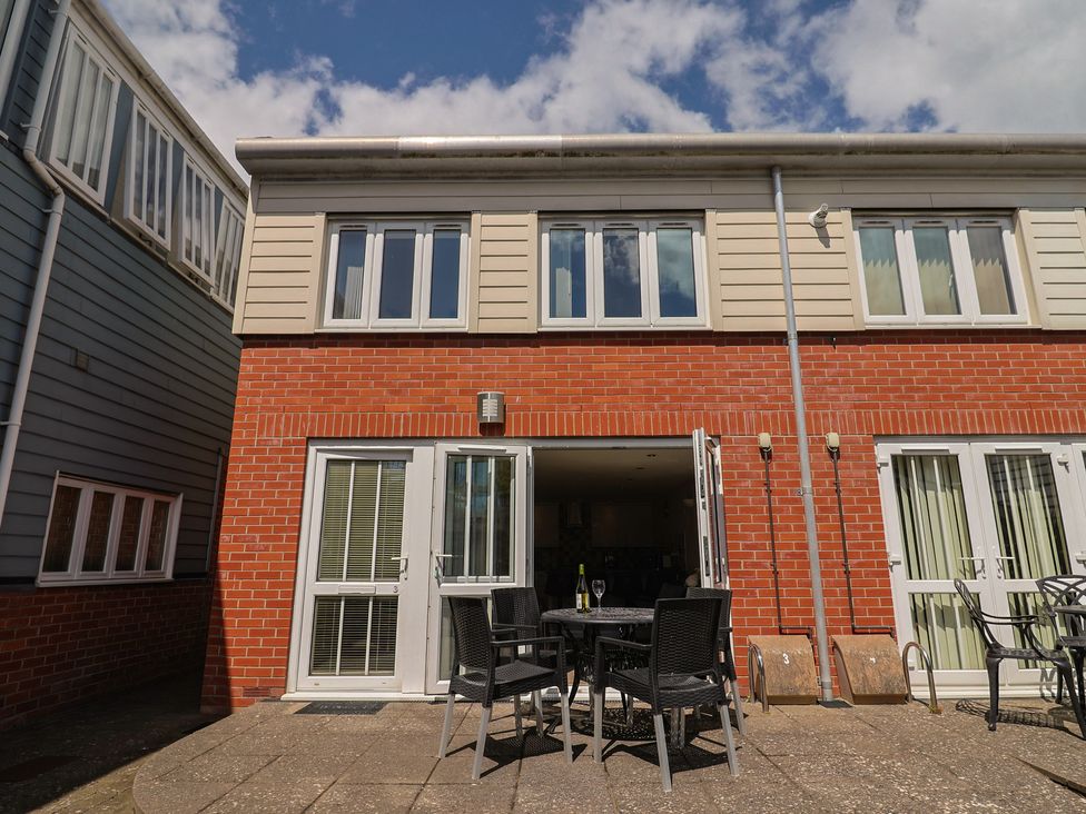 An outdoor area with a table and chairs at Beck House in Weymouth