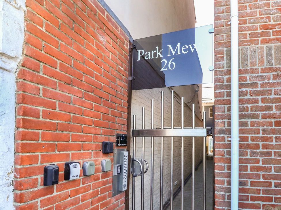 A gate with an address plaque and mailboxes at Park Mews 26 in Weymouth