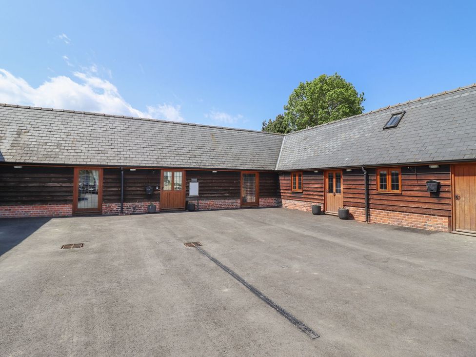 An outdoor area with buildings and pathway at Ysgubor Fachwen Newtown