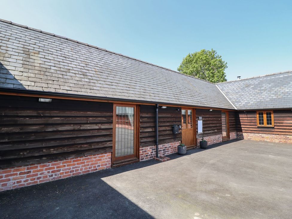Exterior view of a building with a door and windows at Ysgubor Fachwen Newtown