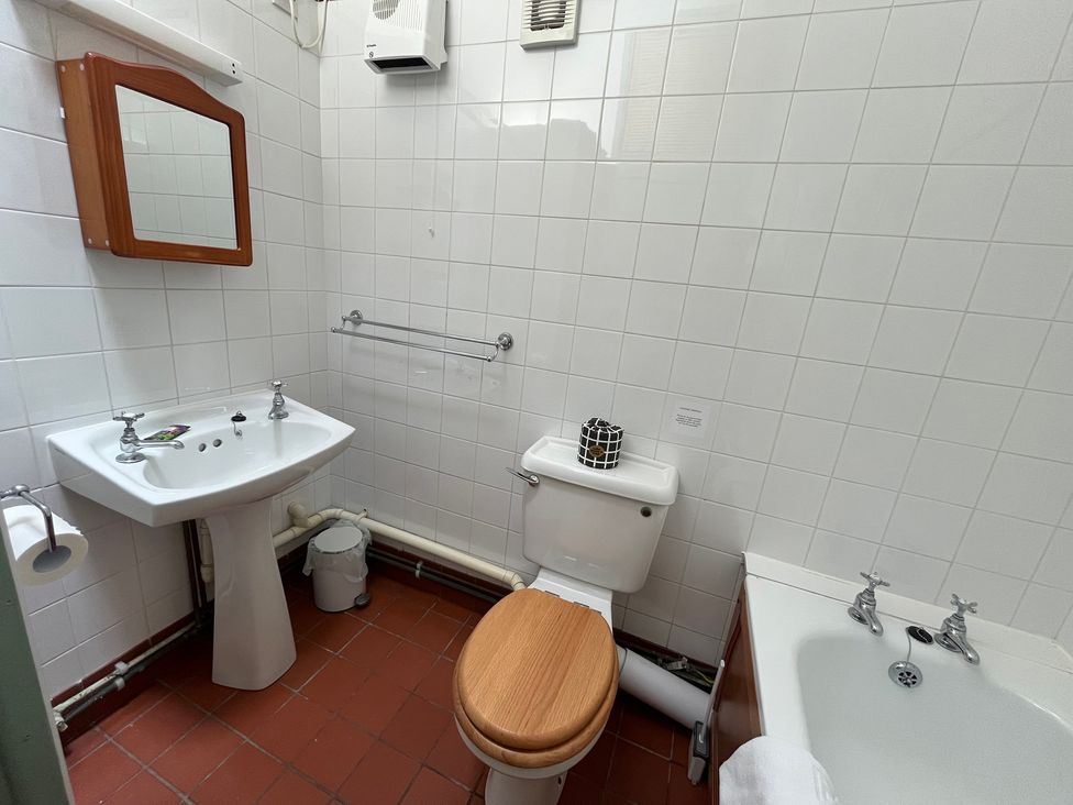 A bathroom with a sink, toilet, and bathtub at Warbler Cottage near Cowbridge