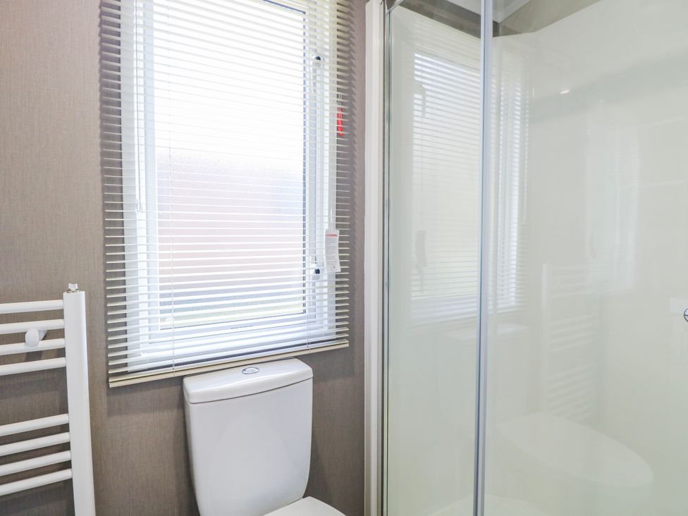 A bathroom with a toilet, shower, window, and radiator at Mustard Pot 111 Foxburrow Hang 