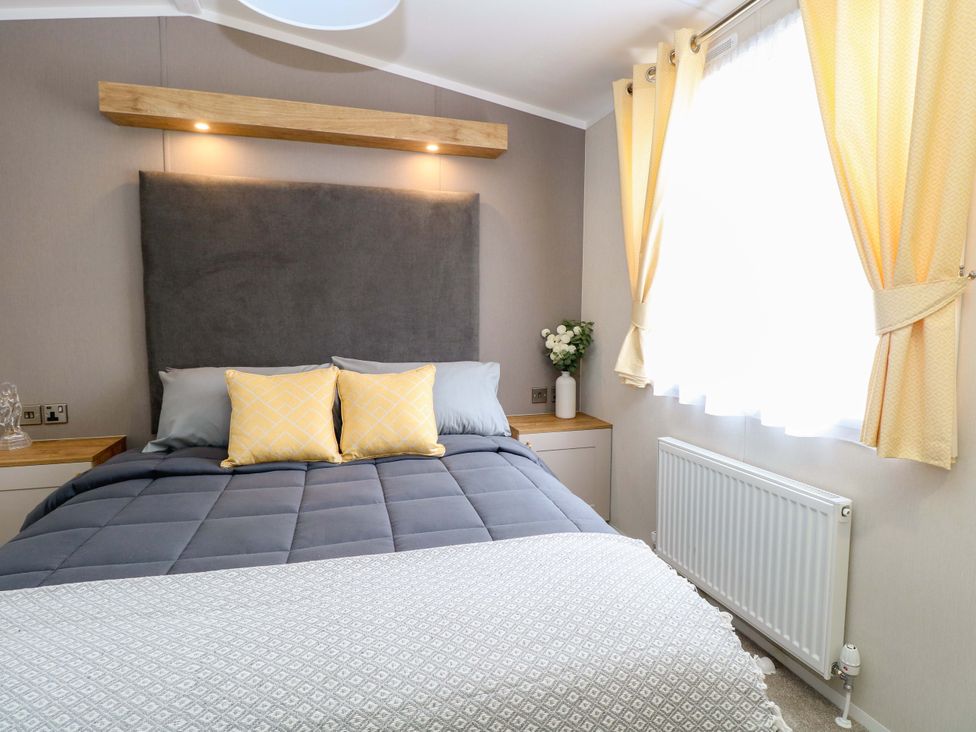 A bedroom with a bed and pillows at The Honey Pot Retreat Fritton near Belton Norfolk