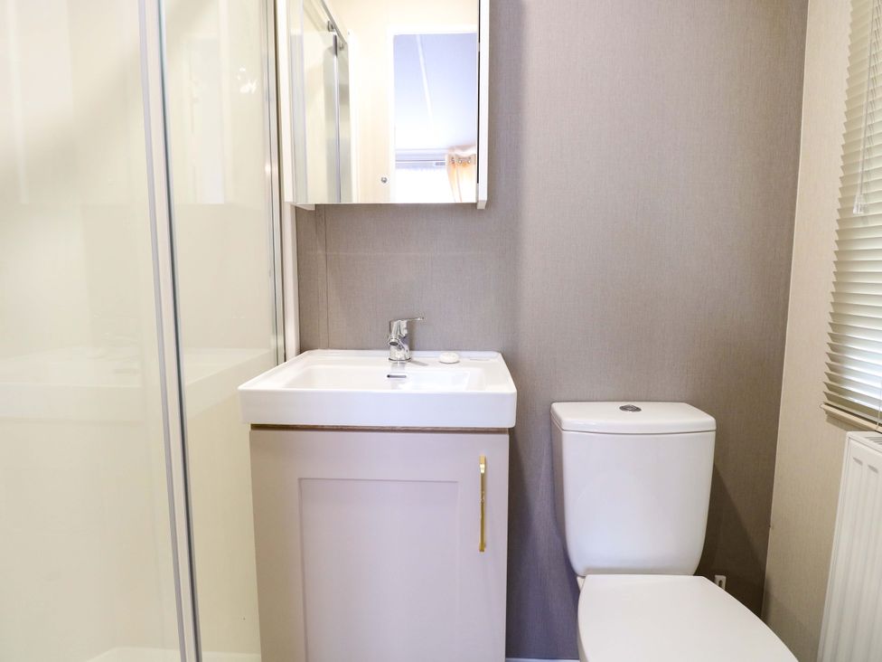 A bathroom with a sink and toilet at The Honey Pot Retreat in Fritton near Belton, Norfolk