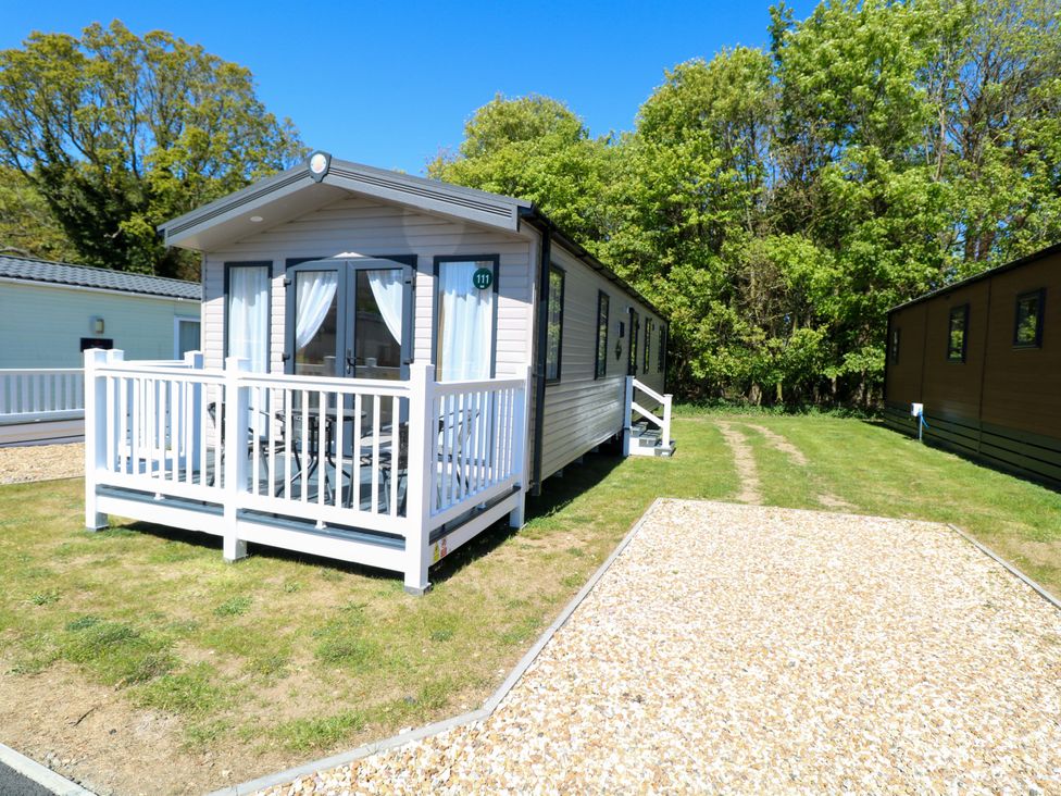 A mobile home with a deck and pathway at The Honey Pot Retreat in Fritton near Belton, Norfolk
