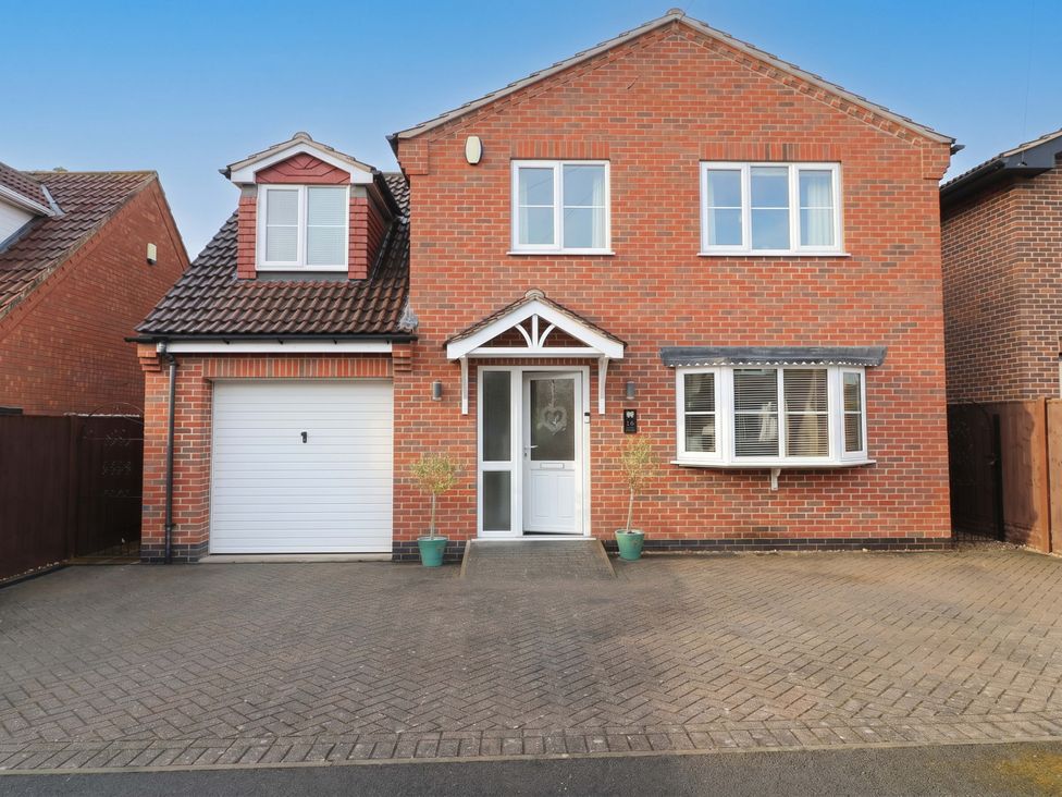 A house with a garage and plants at 16 Temple Crescent, Nuthall