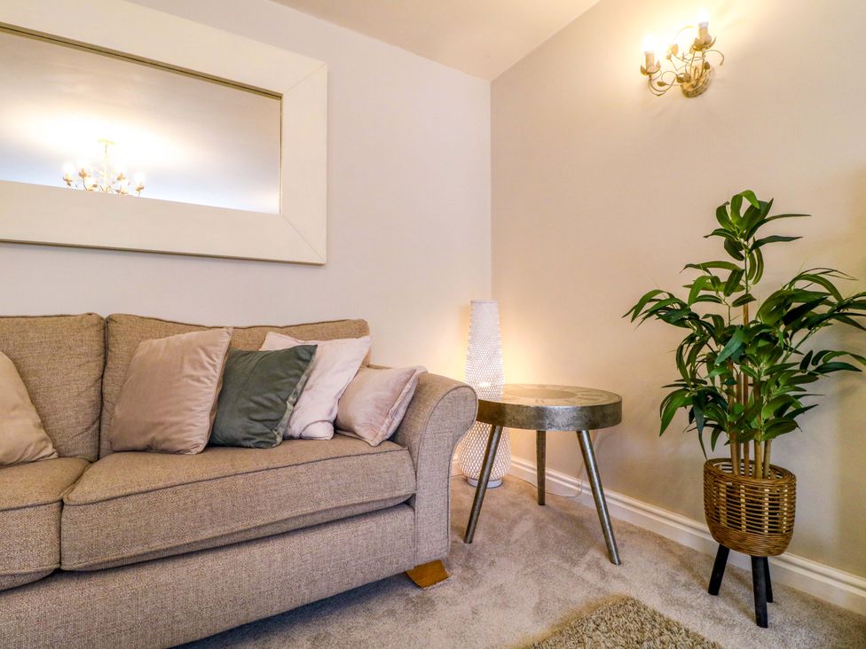 A living room with a sofa and side table at 16 Temple Crescent Nuthall