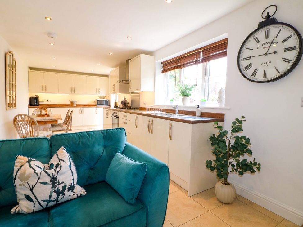 A kitchen with a sofa and dining area at 16 Temple Crescent in Nuthall