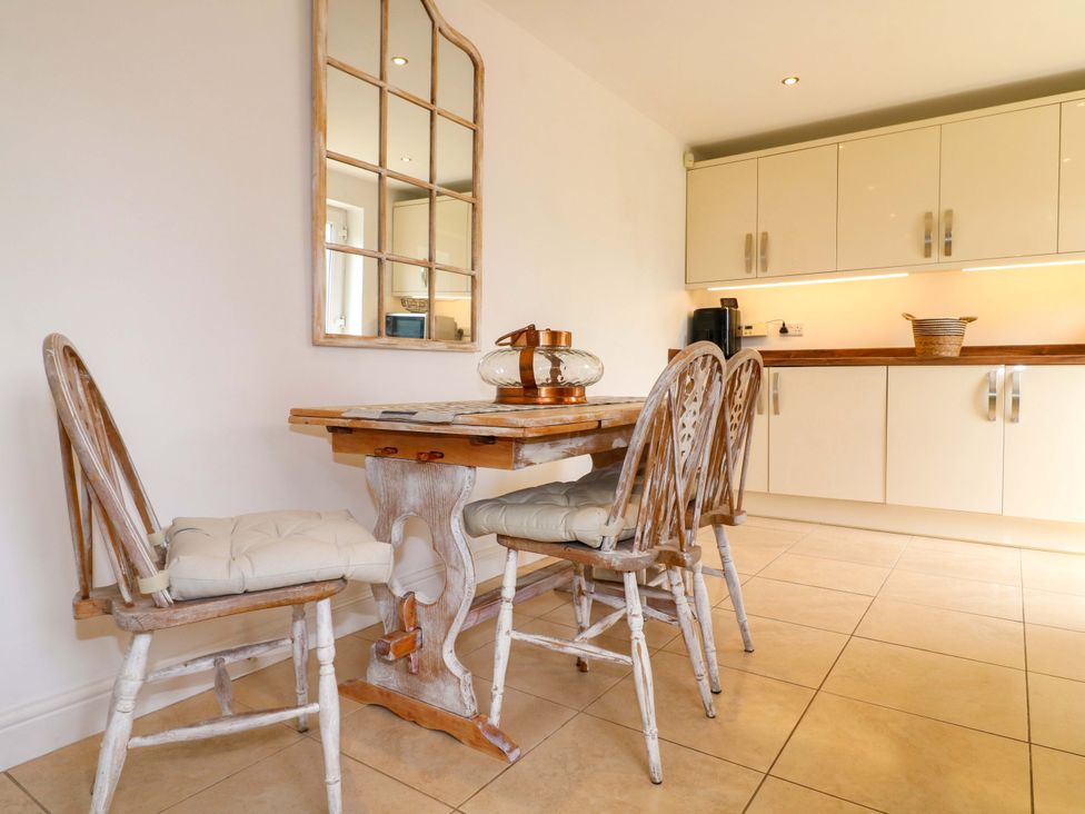 A kitchen with a table and chairs at 16 Temple Crescent in Nuthall