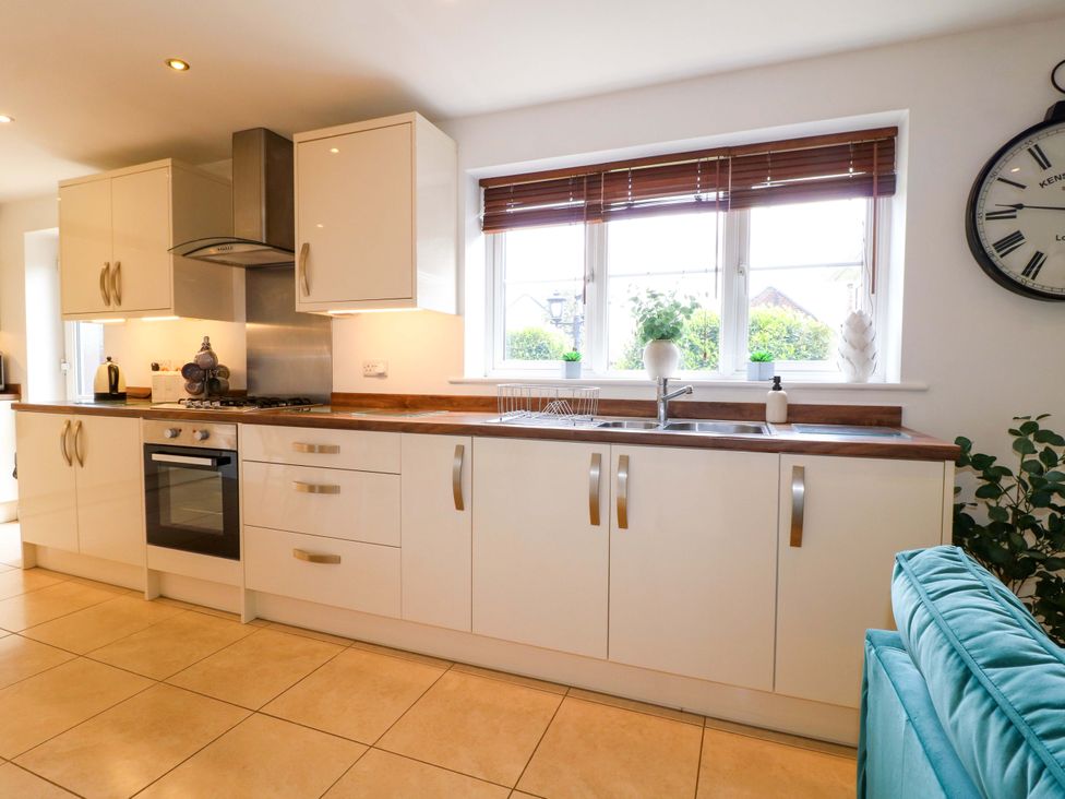 A kitchen with cabinets and a sink at 16 Temple Crescent Nuthall