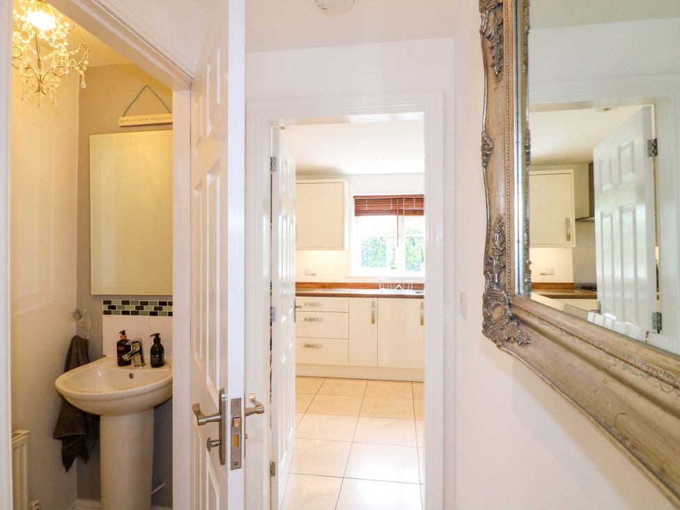 A bathroom with a sink and mirror at 16 Temple Crescent Nuthall