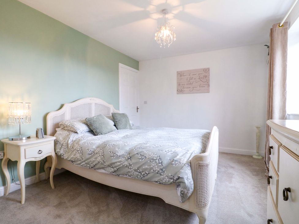 A bedroom with a bed and nightstand at 16 Temple Crescent, Nuthall