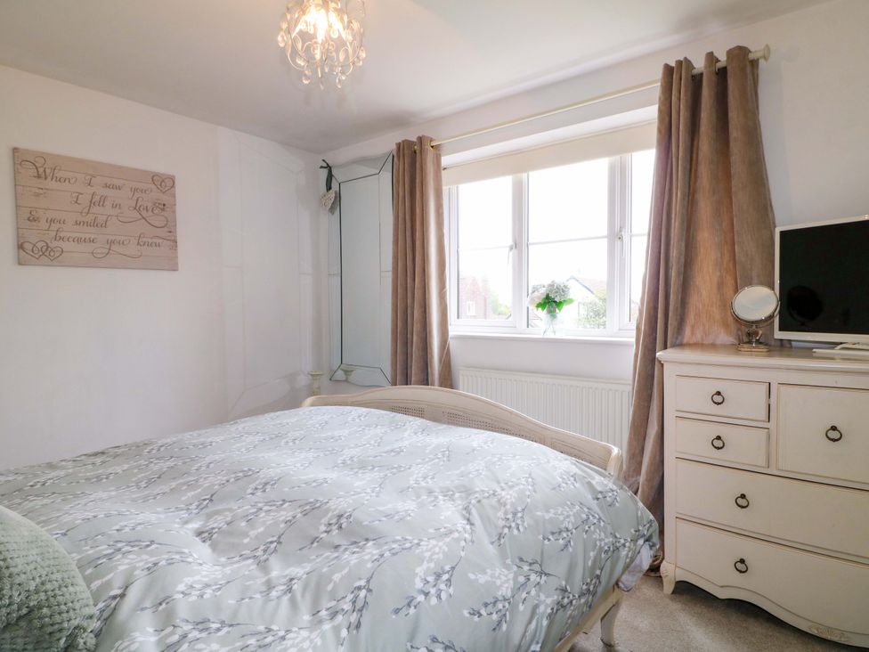 A bedroom with a bed and a dresser at 16 Temple Crescent Nuthall