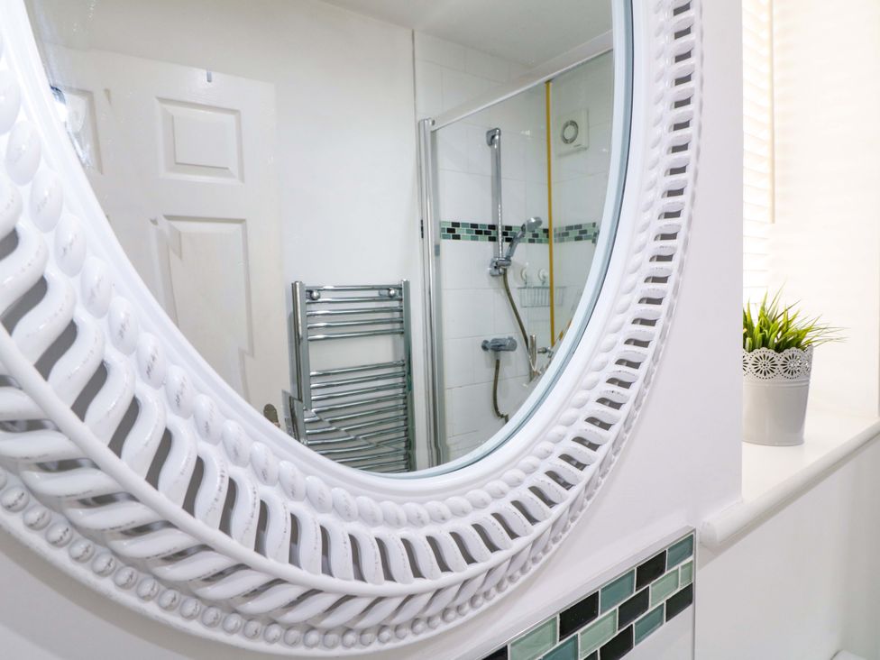 A bathroom featuring a mirror and a shower at 16 Temple Crescent Nuthall