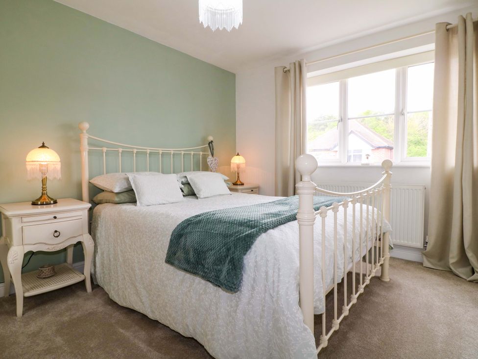A bedroom with a bed and lamps at 16 Temple Crescent Nuthall