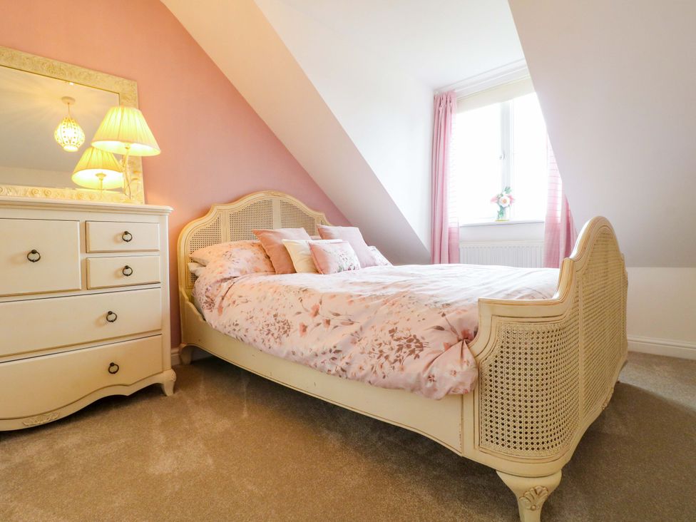 A bedroom with a bed and dresser at 16 Temple Crescent in Nuthall