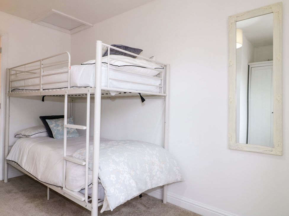 A bedroom with a bunk bed and a mirror at 16 Temple Crescent Nuthall