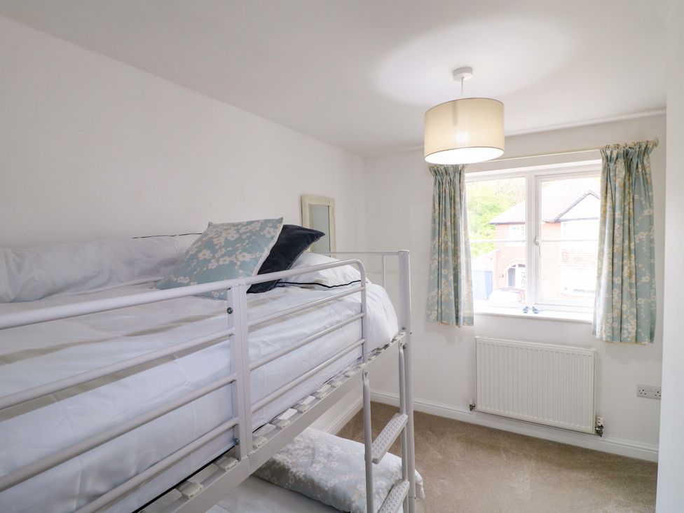 A bedroom with a bunk bed and window at 16 Temple Crescent in Nuthall