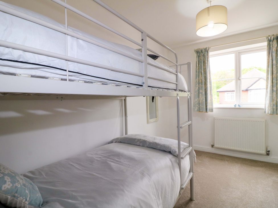 A bedroom with a bunk bed and a single bed at 16 Temple Crescent Nuthall