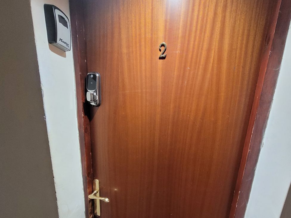 An entrance door with number 2 and an electronic lock at Palace Court