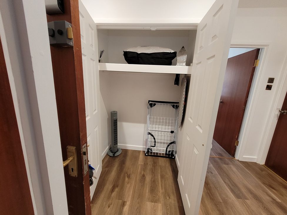 A storage room with a shelf and various items at Palace Court in Buxton
