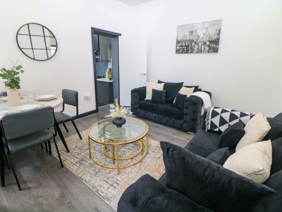 A living room with a sofa and dining table at 22 Garfield Street Stoke-on-Trent