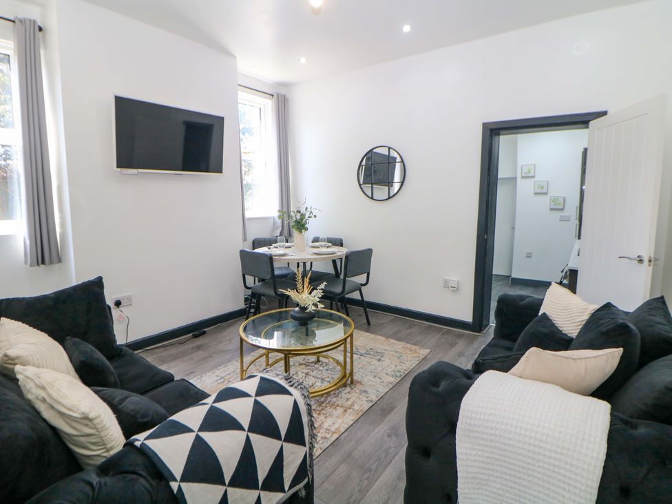 A living room with a sofa and table at 22 Garfield Street in Stoke-on-Trent