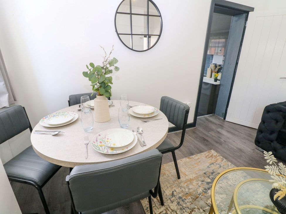 A dining room with a round table and chairs at 22 Garfield Street in Stoke-on-Trent