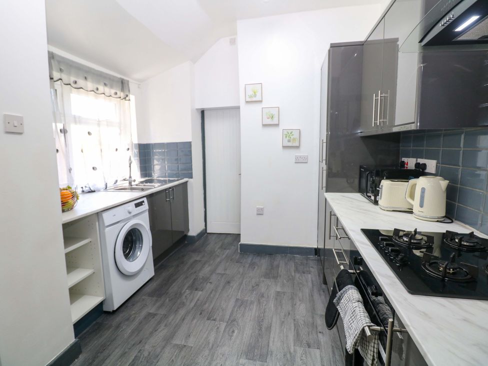 A kitchen with appliances and a washing machine at 22 Garfield Street Stoke-on-Trent