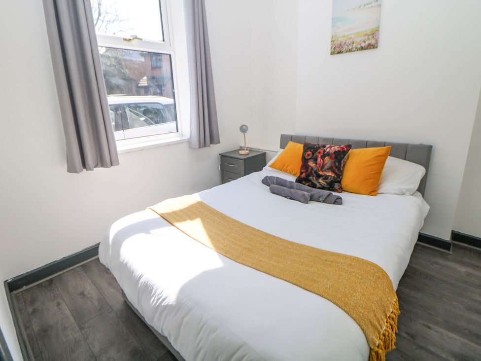 A bedroom with a bed and nightstand at 22 Garfield Street Stoke-on-Trent