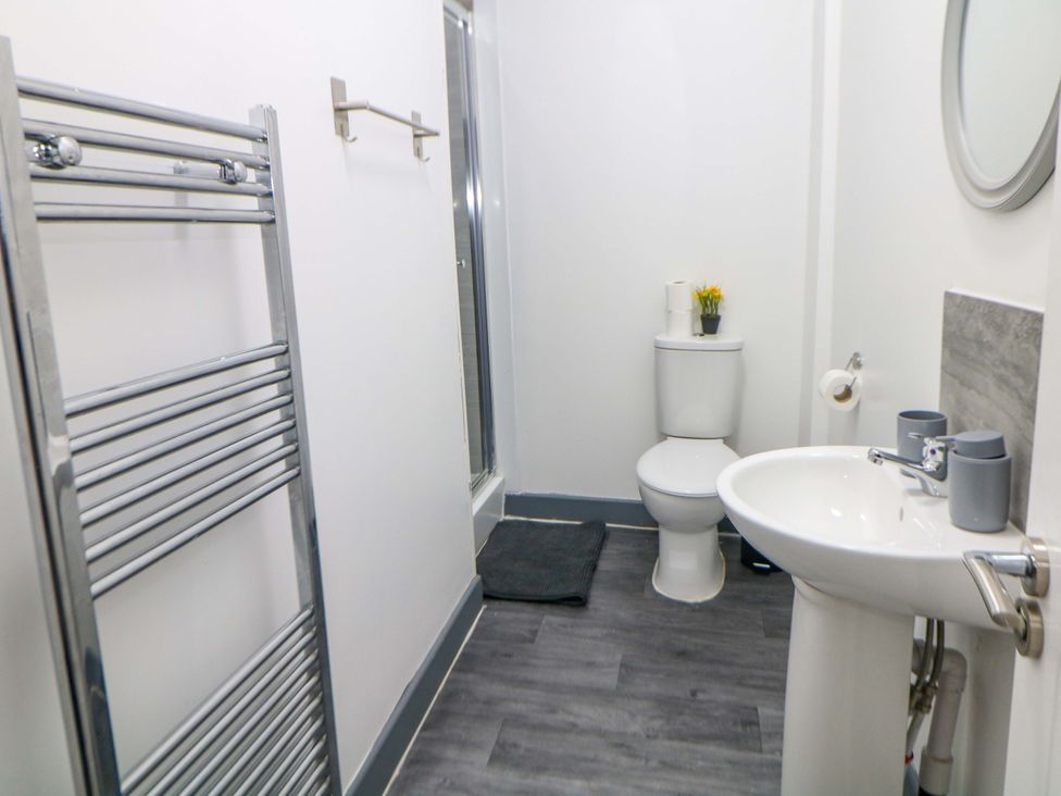 A bathroom with a toilet and sink at 22 Garfield Street in Stoke-on-Trent