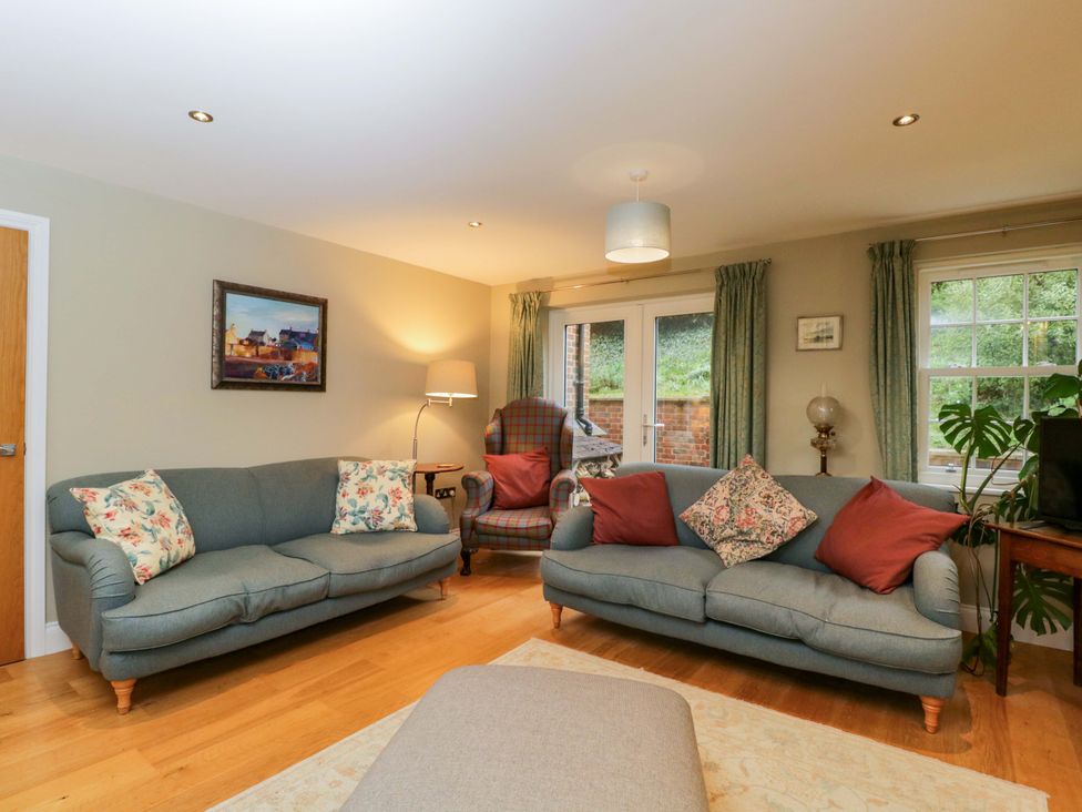 A living room with sofas and an armchair at Ormiston House Netheravon