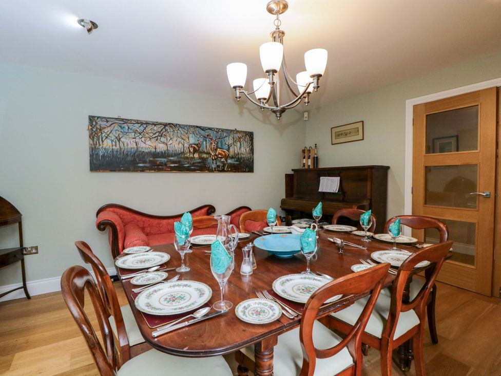 A dining room with a table set for dinner at Ormiston House in Netheravon