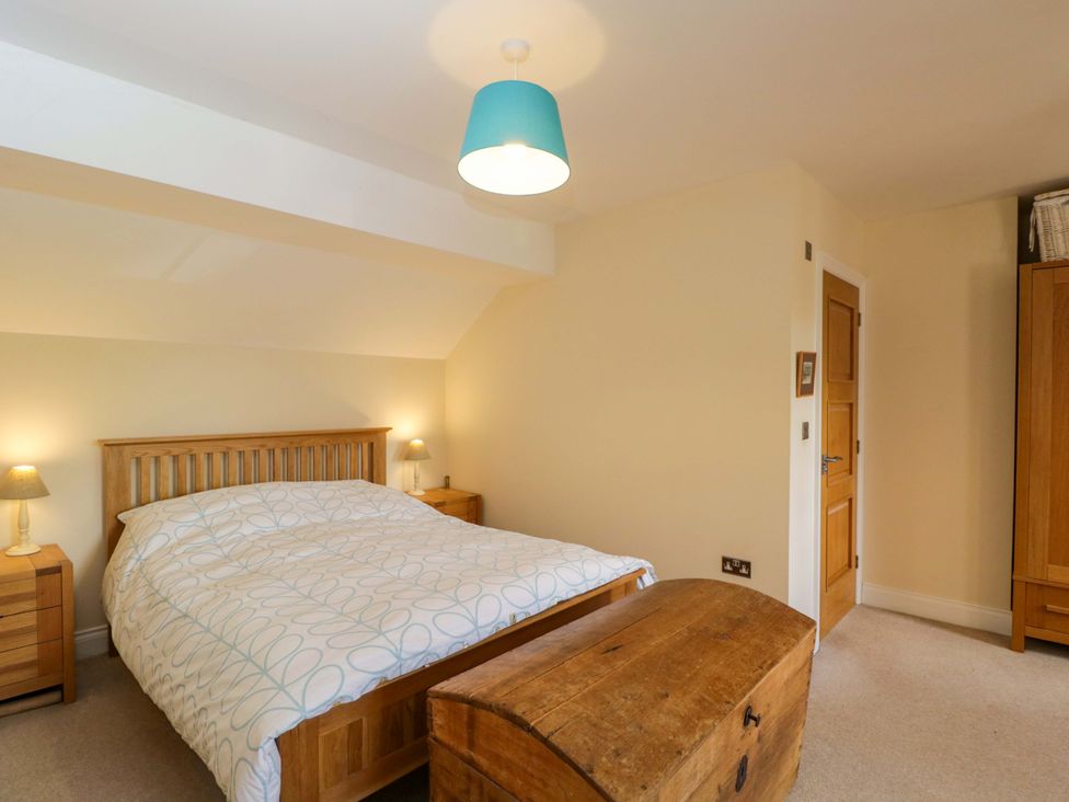 A bedroom with a bed and a wardrobe at Ormiston House in Netheravon