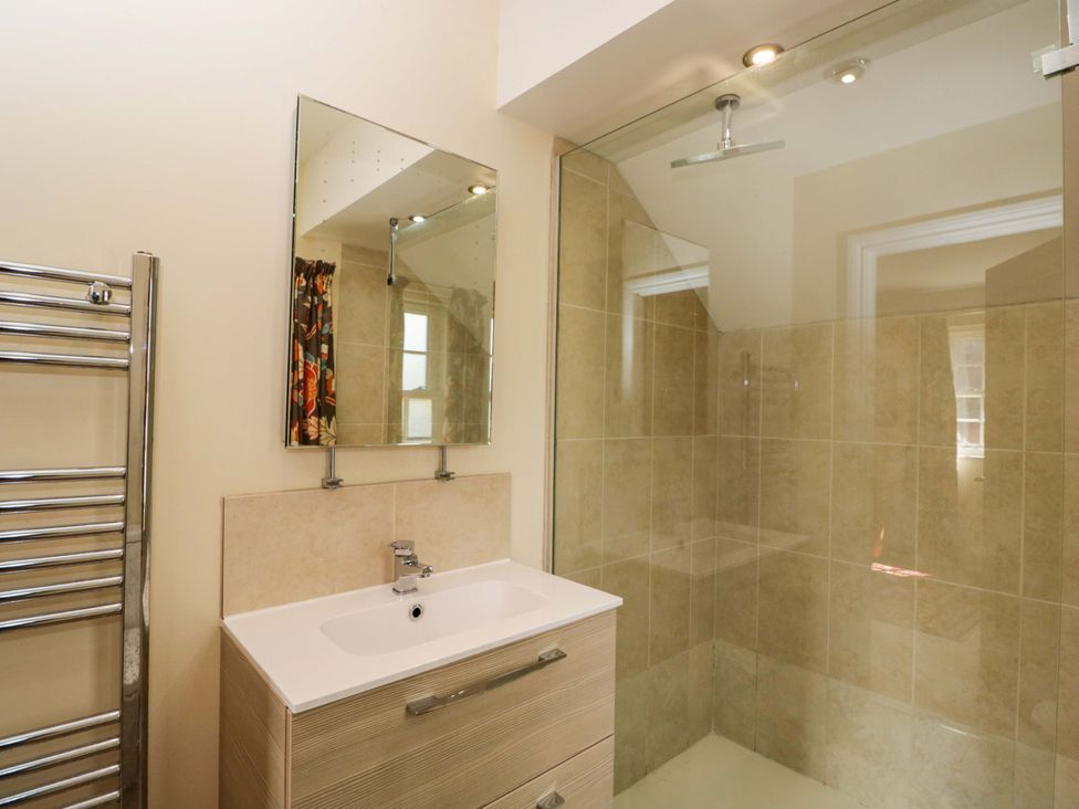 A bathroom with a shower and sink at Ormiston House in Netheravon