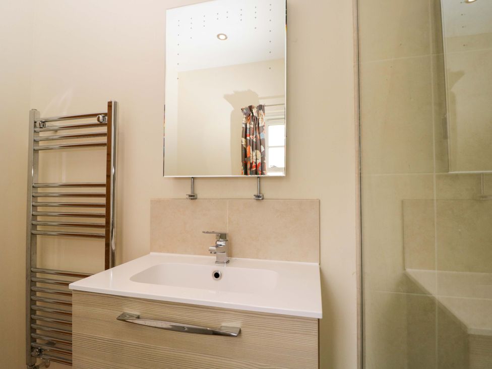 A bathroom with a sink and mirror at Ormiston House in Netheravon