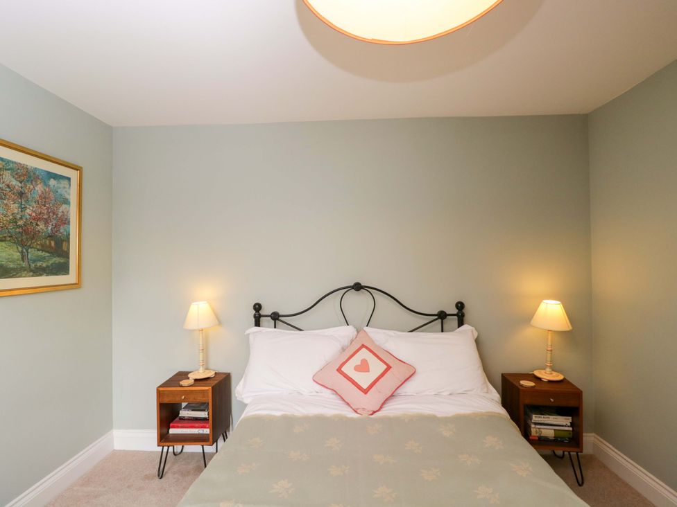 A bedroom with a bed and bedside tables at Ormiston House in Netheravon