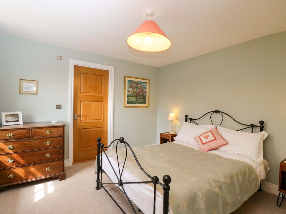 A bedroom with a bed and a chest of drawers at Ormiston House Netheravon
