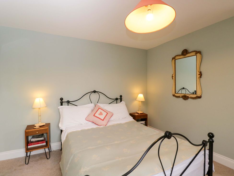 A bedroom with a bed and bedside table at Ormiston House in Netheravon