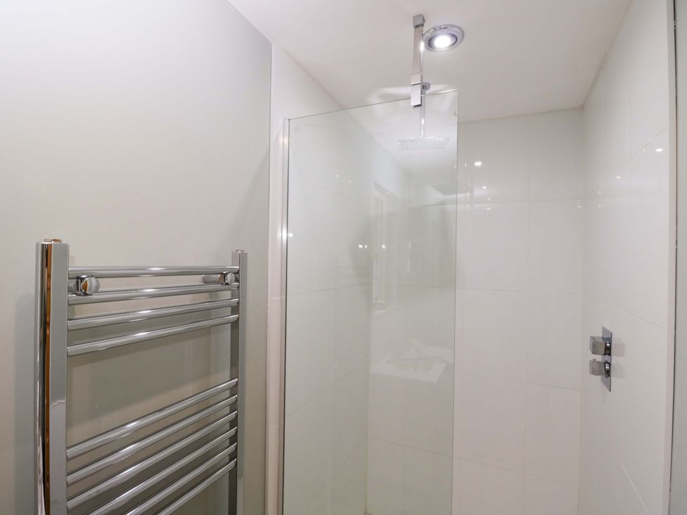 A shower with a towel warmer in the bathroom at Ormiston House in Netheravon