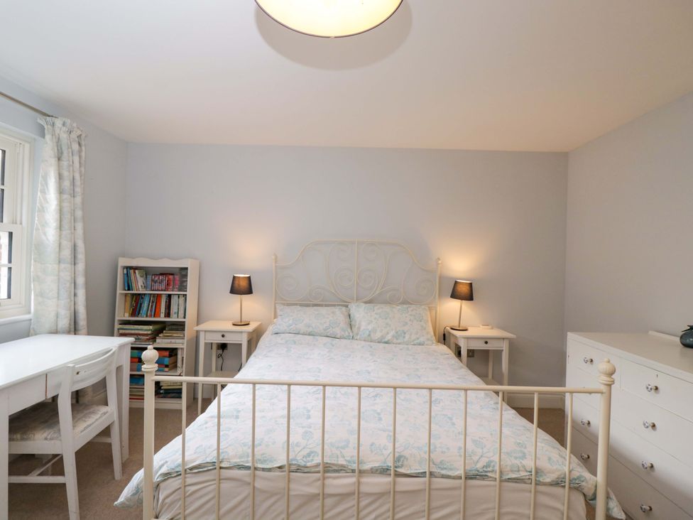 A bedroom with a bed and bookshelf at Ormiston House Netheravon
