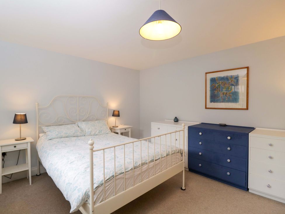 A bedroom with a bed and light fixtures at Ormiston House in Netheravon