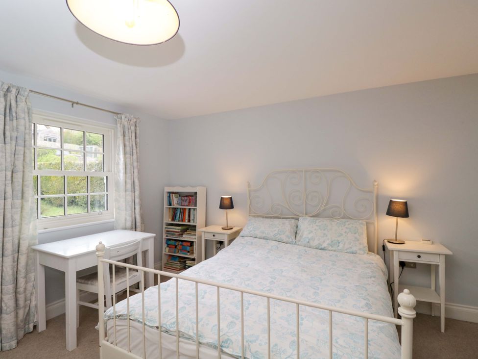 A bedroom with a bed and study area at Ormiston House in Netheravon