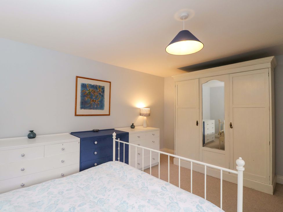 A bedroom with a bed, wardrobe and chest of drawers at Ormiston House Netheravon